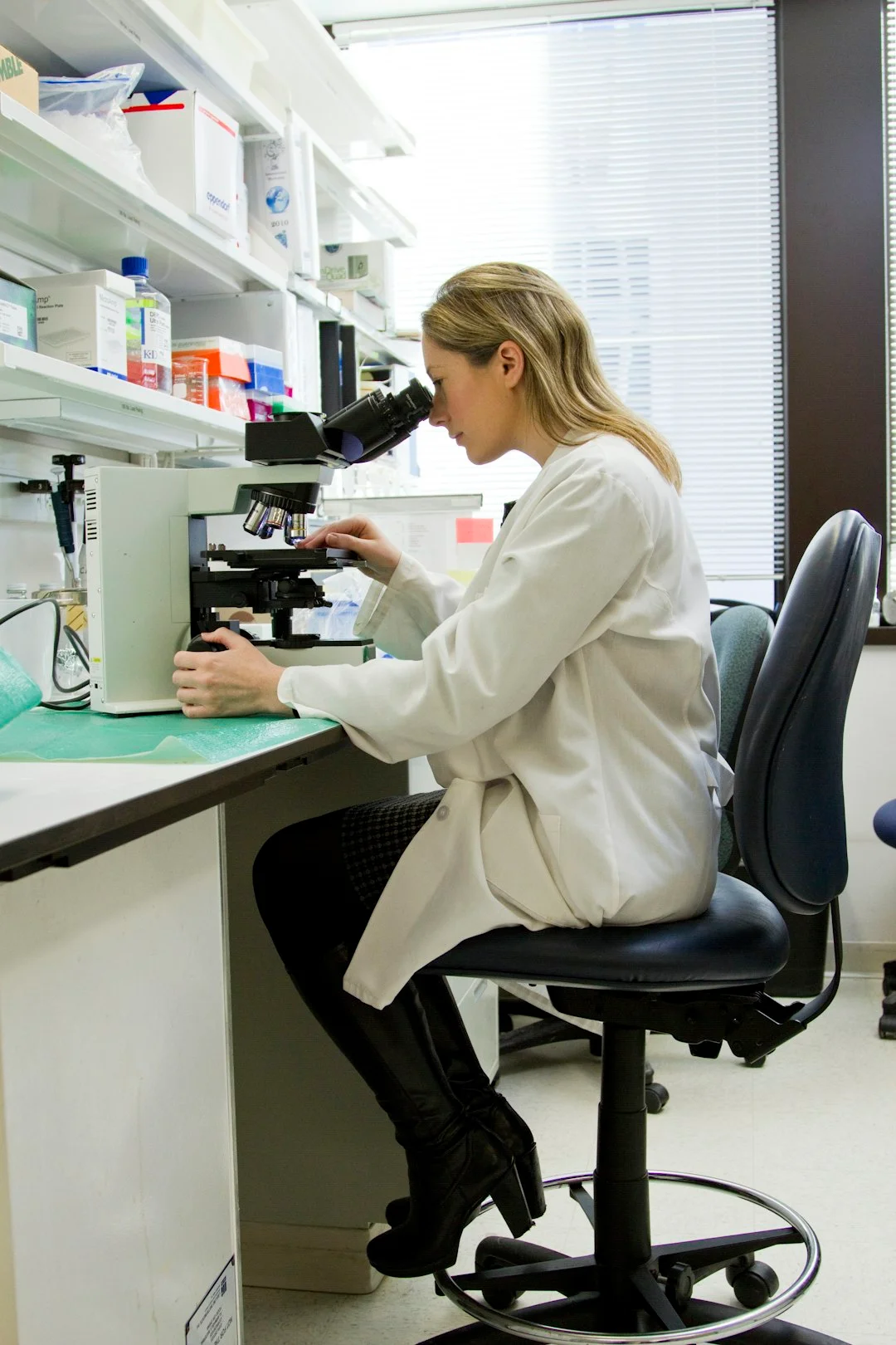 Researcher working at a microscope in a laboratory